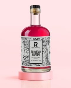 A Pornstar Martini bottle sitting on a Pink stand
