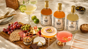 Chilled cocktails served in coupe and highball glasses with citrus and mint garnishes